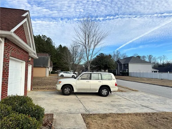 a view of parking space in front of a house