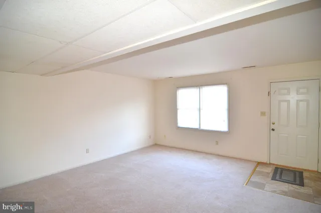 an empty room with a empty space and windows
