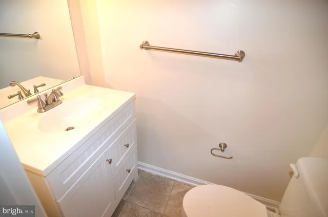 a bathroom with a sink mirror vanity and toilet