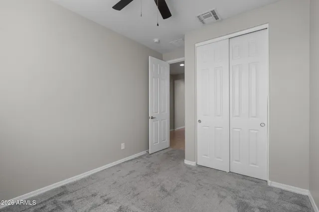 an empty room with closet area