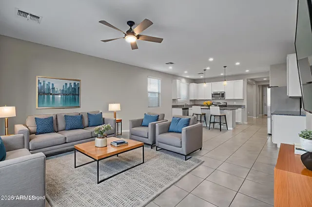 a living room with furniture and kitchen view