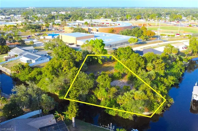 an aerial view of residential houses with outdoor space and swimming pool