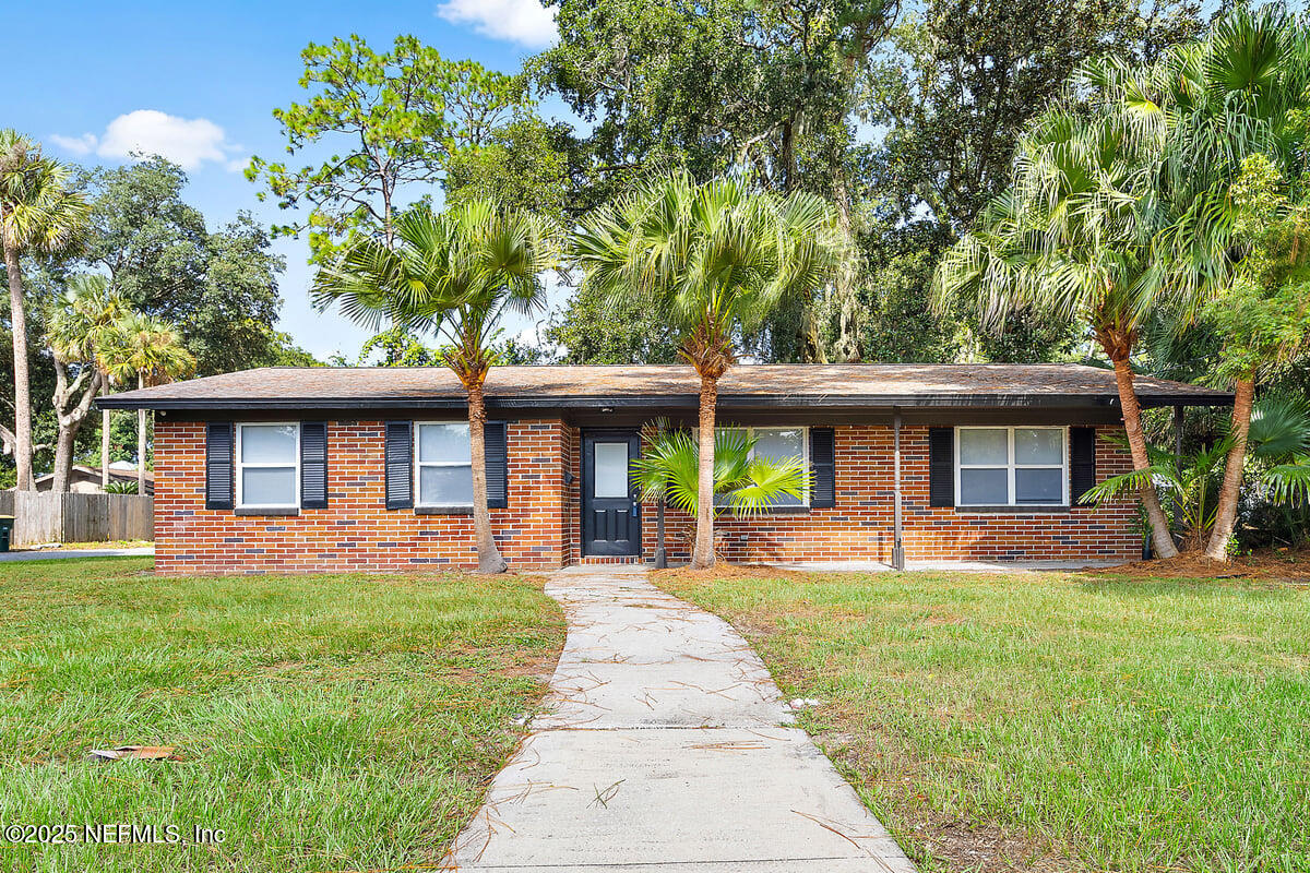 a front view of house with yard and green space