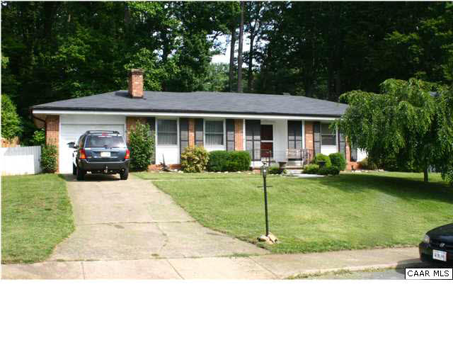 1423 Ricky Road Charlottesville, VA 22901 - Photo 1 of 16 a front view of a house with a garden and trees