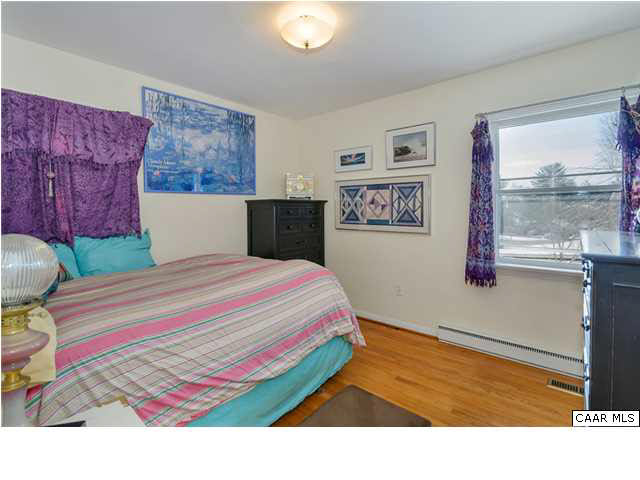 1423 Ricky Road Charlottesville, VA 22901 - Photo 11 of 16 a bedroom with a bed and painting on the wall