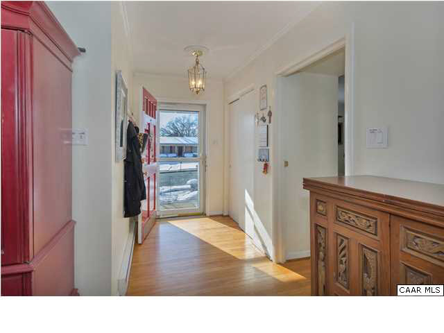 1423 Ricky Road Charlottesville, VA 22901 - Photo 3 of 16 a hallway with wooden floor and windows