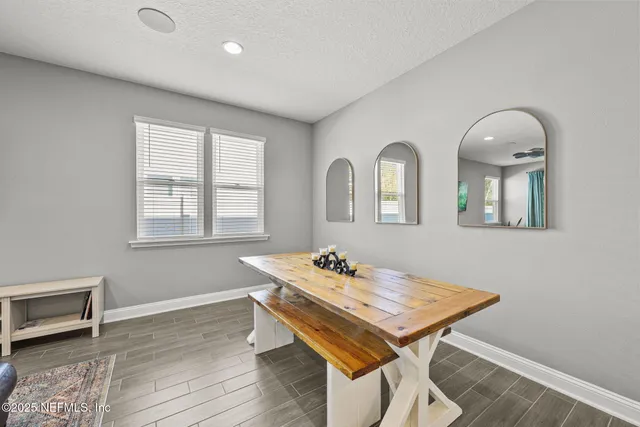 a dining room with furniture and window