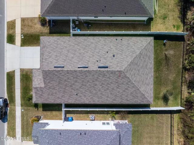 an aerial view of residential houses with outdoor space and swimming pool
