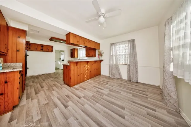 a spacious bedroom with a bed and a flat screen tv