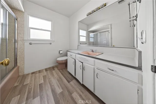 a spacious bathroom with a granite countertop sink mirror and toilet
