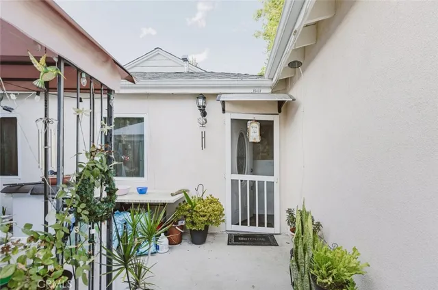 front view of a house with potted plants