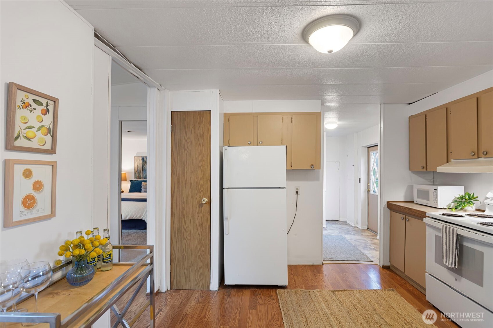 19015 16th Avenue Northeast Shoreline, WA 98155 - Photo 24 of 38 a kitchen with stainless steel appliances granite countertop a refrigerator and a stove top oven