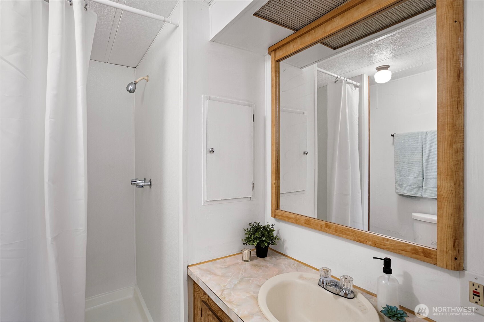 19015 16th Avenue Northeast Shoreline, WA 98155 - Photo 28 of 37 a bathroom with a sink and a mirror