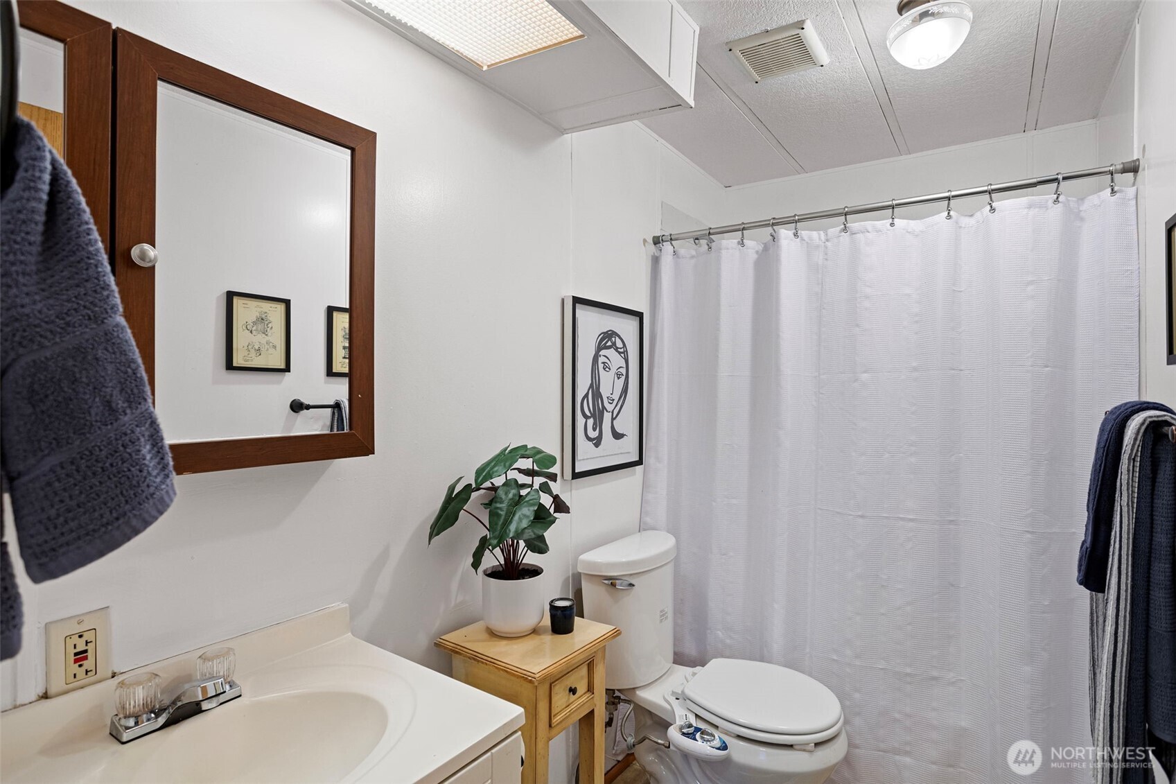 19015 16th Avenue Northeast Shoreline, WA 98155 - Photo 32 of 38 a bathroom with a sink mirror vanity and toilet