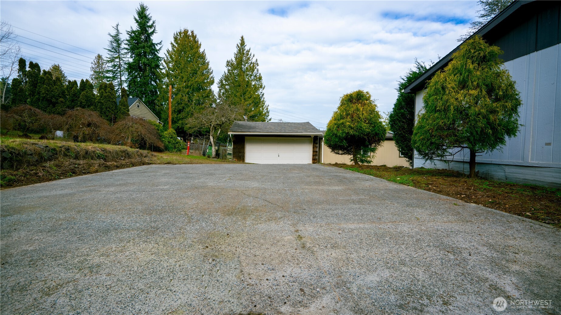 19015 16th Avenue Northeast Shoreline, WA 98155 - Photo 4 of 38 a view of a house with backyard and trees