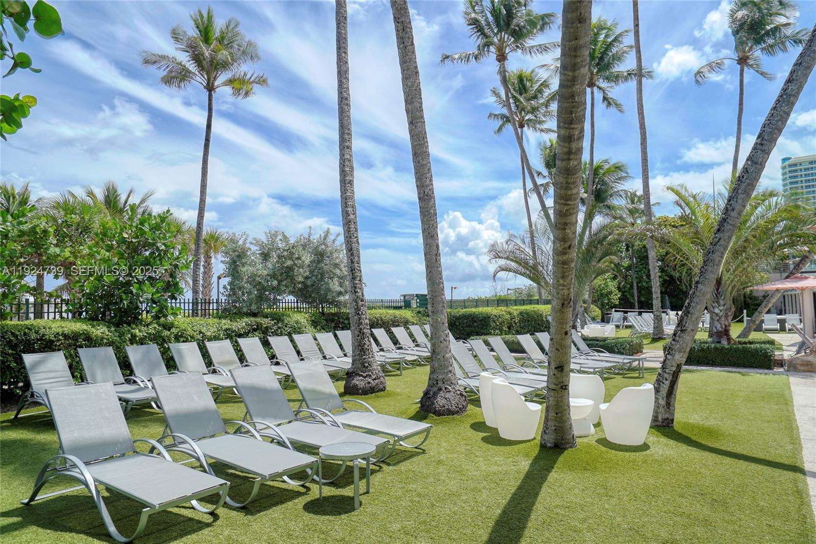 5225 Collins Avenue, Unit 1204 Miami Beach, FL 33140 - Photo 11 of 49 a view of a swimming pool with chairs