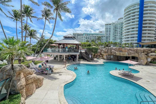 a view of a swimming pool with outdoor seating
