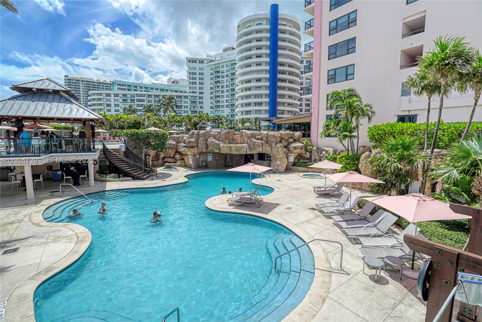 5225 Collins Avenue, Unit 1204 Miami Beach, FL 33140 - Photo 14 of 49 a view of a swimming pool with outdoor seating