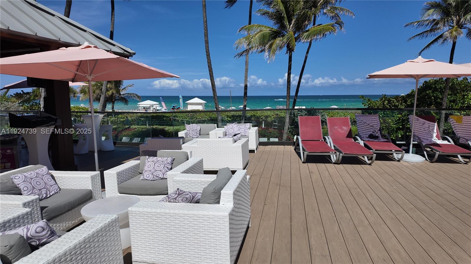 5225 Collins Avenue, Unit 1204 Miami Beach, FL 33140 - Photo 18 of 49 a view of a patio with couches under an umbrella