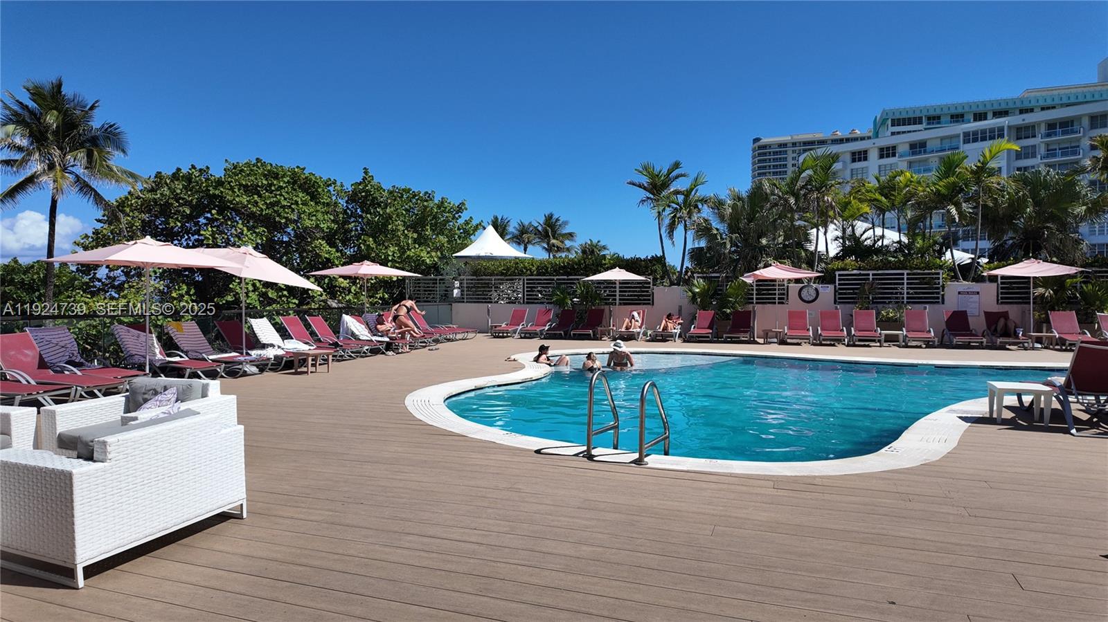 5225 Collins Avenue, Unit 1204 Miami Beach, FL 33140 - Photo 19 of 49 a view of a swimming pool with a patio