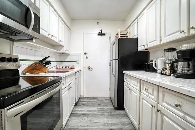 a bedroom with a large bed and a tv