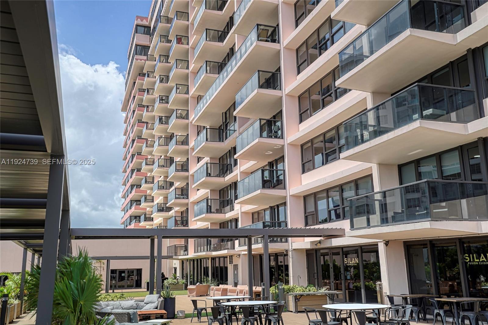 5225 Collins Avenue, Unit 1204 Miami Beach, FL 33140 - Photo 7 of 49 a front view of a multi story building