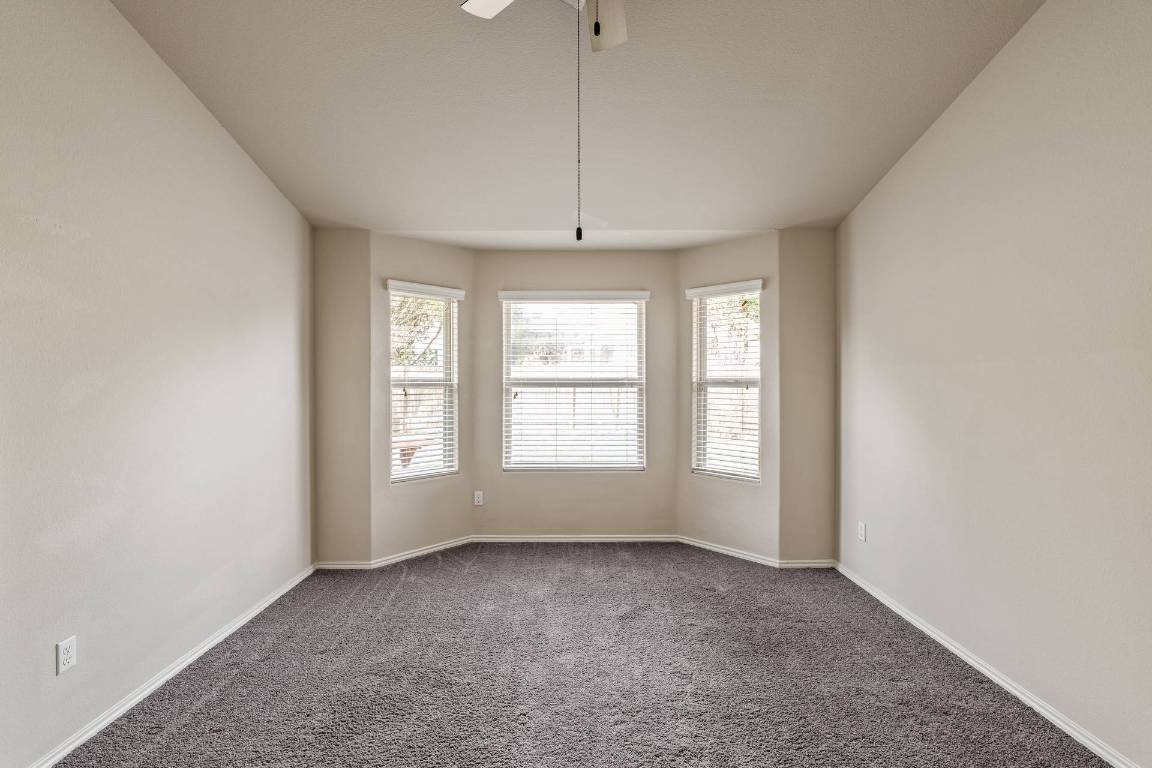 180 Fletcher Bend Buda, TX 78610 - Photo 15 of 36 a view of an empty room with a window