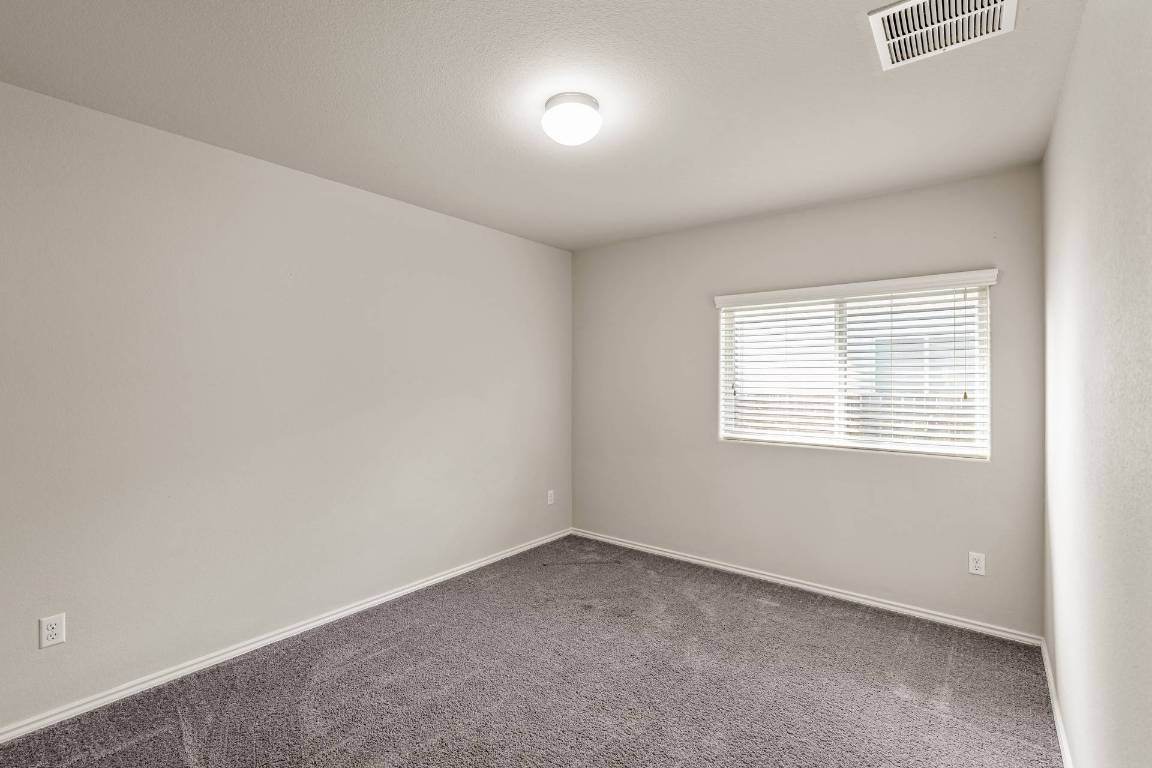 180 Fletcher Bend Buda, TX 78610 - Photo 21 of 36 an empty room with a window