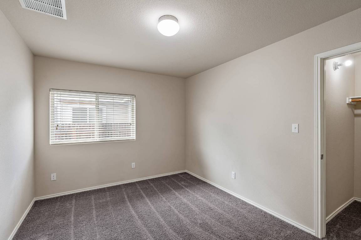 180 Fletcher Bend Buda, TX 78610 - Photo 24 of 36 an empty room with a window