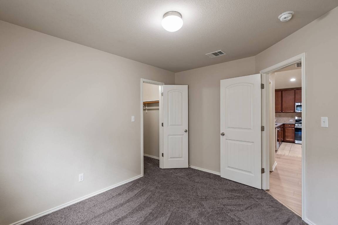 180 Fletcher Bend Buda, TX 78610 - Photo 25 of 36 wooden floor in an empty room