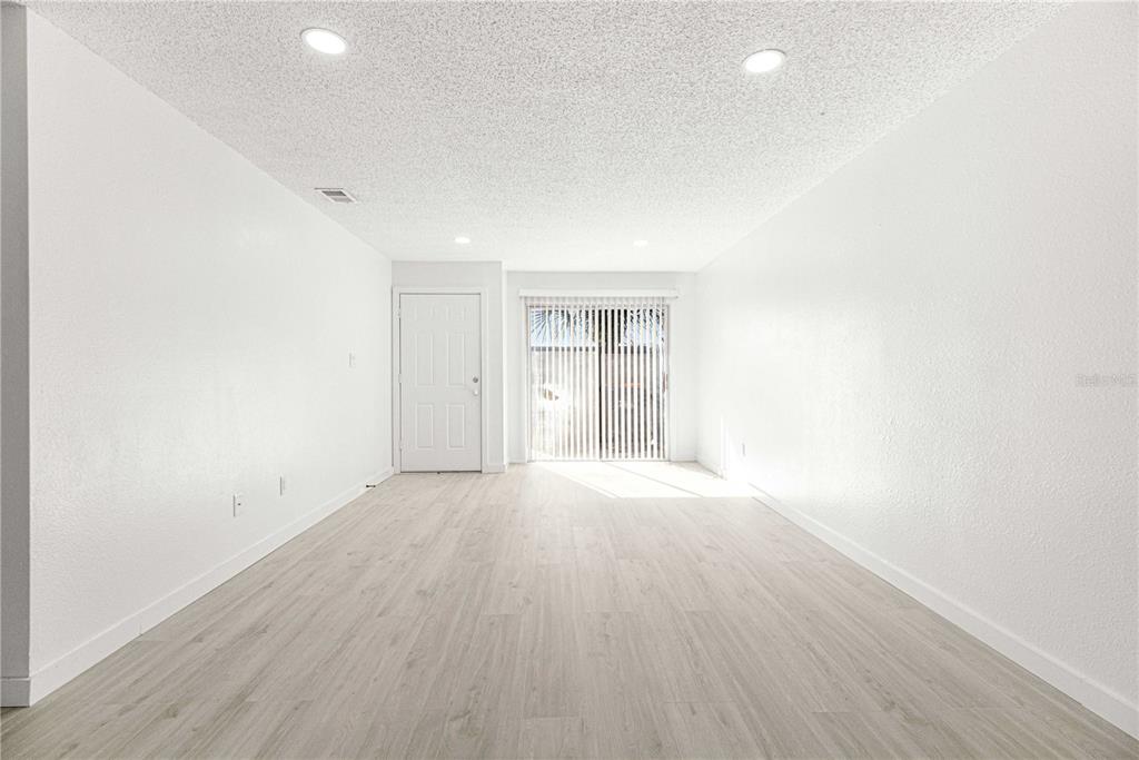 5355 Southeast 29th Place Ocala, FL 34480 - Photo 4 of 8 an empty room with wooden floor and windows