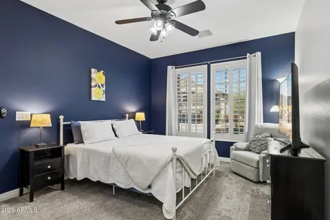 a bedroom with a bed and a potted plant