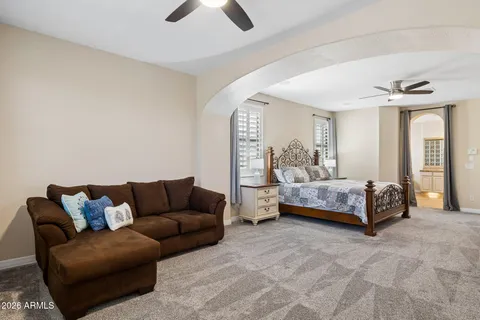 a bedroom with a bed and a chandelier