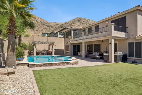 a view of a house with backyard porch and sitting area