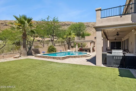 a view of a house with swimming pool and sitting area