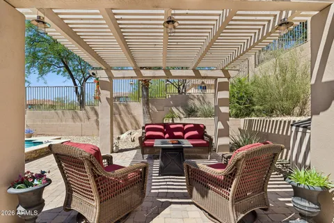 a view of a house with backyard and sitting area