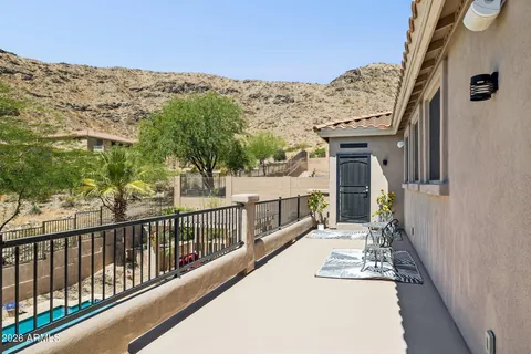 an outdoor sitting area with furniture and garden view