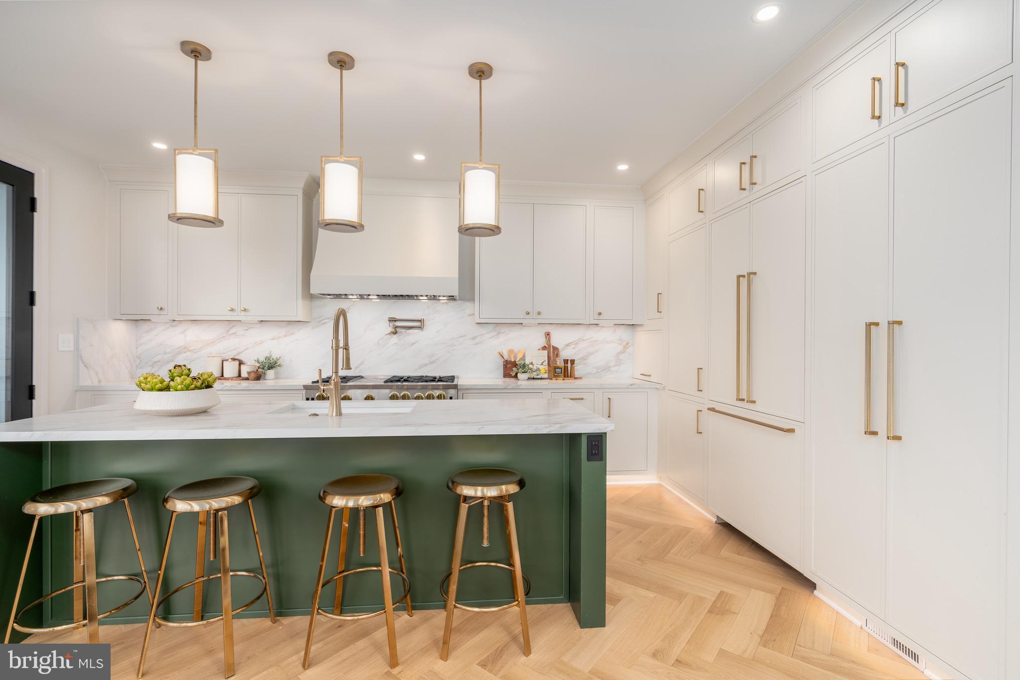 2619 Wisconsin Avenue Northwest Washington, DC 20007 - Photo 13 of 63 a kitchen with stainless steel appliances kitchen island granite countertop a table chairs and white cabinets