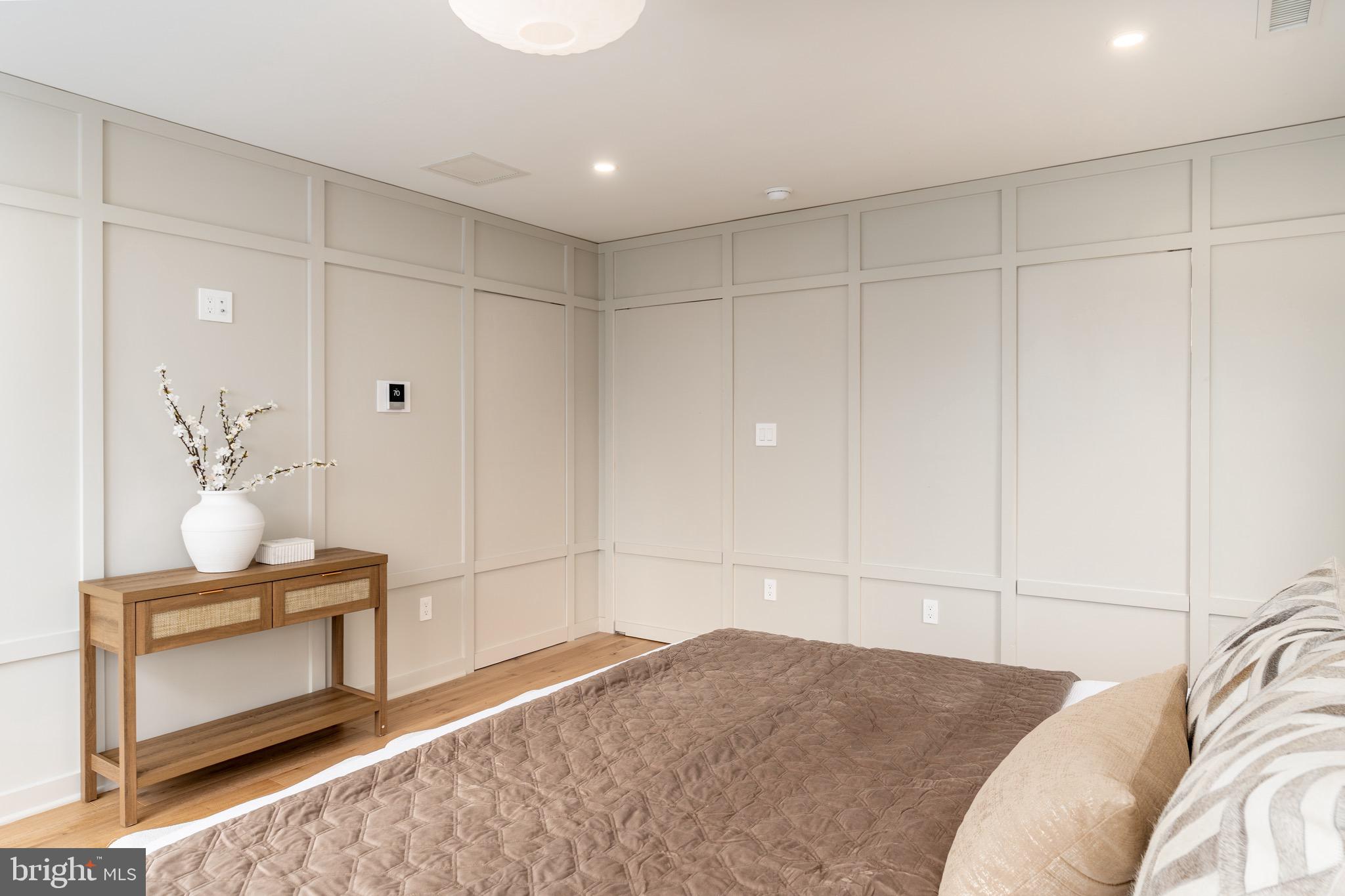 2619 Wisconsin Avenue Northwest Washington, DC 20007 - Photo 24 of 63 a bedroom with a bed and chandelier