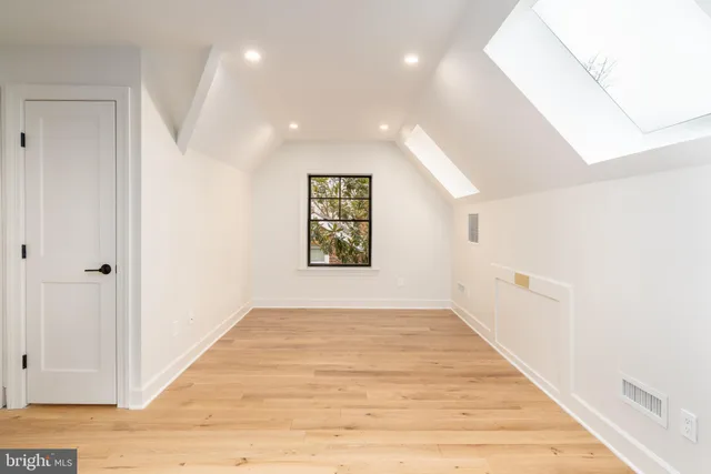 a living room with furniture and a lamp