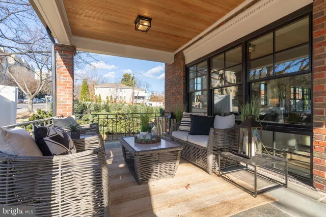 a view of a hallway with wooden floor and windows