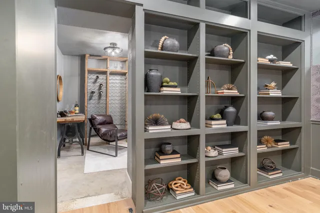 a bedroom with a bed and a potted plant next to a window