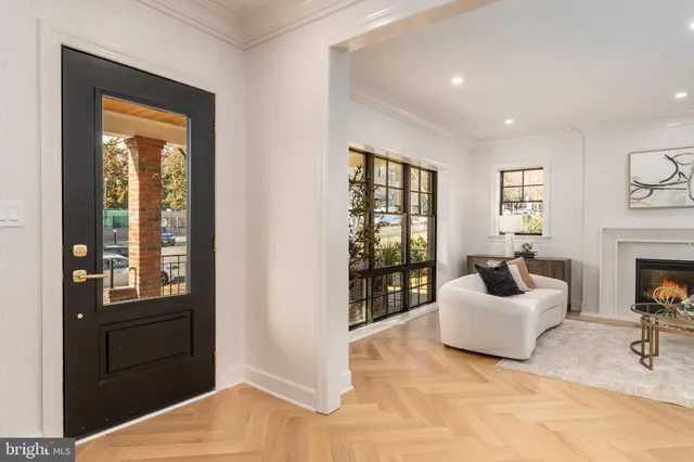 a living room with furniture a fireplace and a window