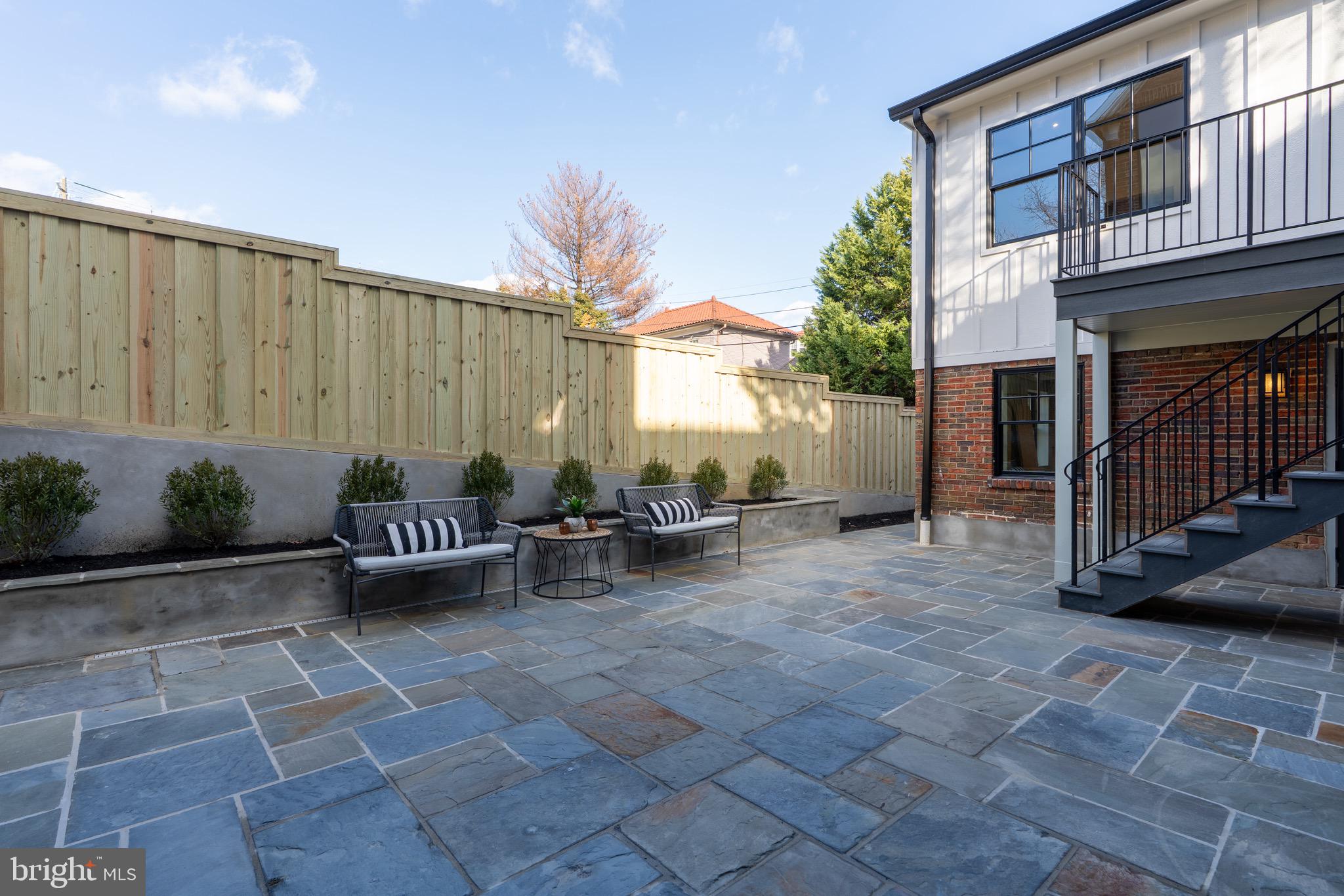 2619 Wisconsin Avenue Northwest Washington, DC 20007 - Photo 55 of 63 a view of a patio with table and chairs with plants and wooden fence