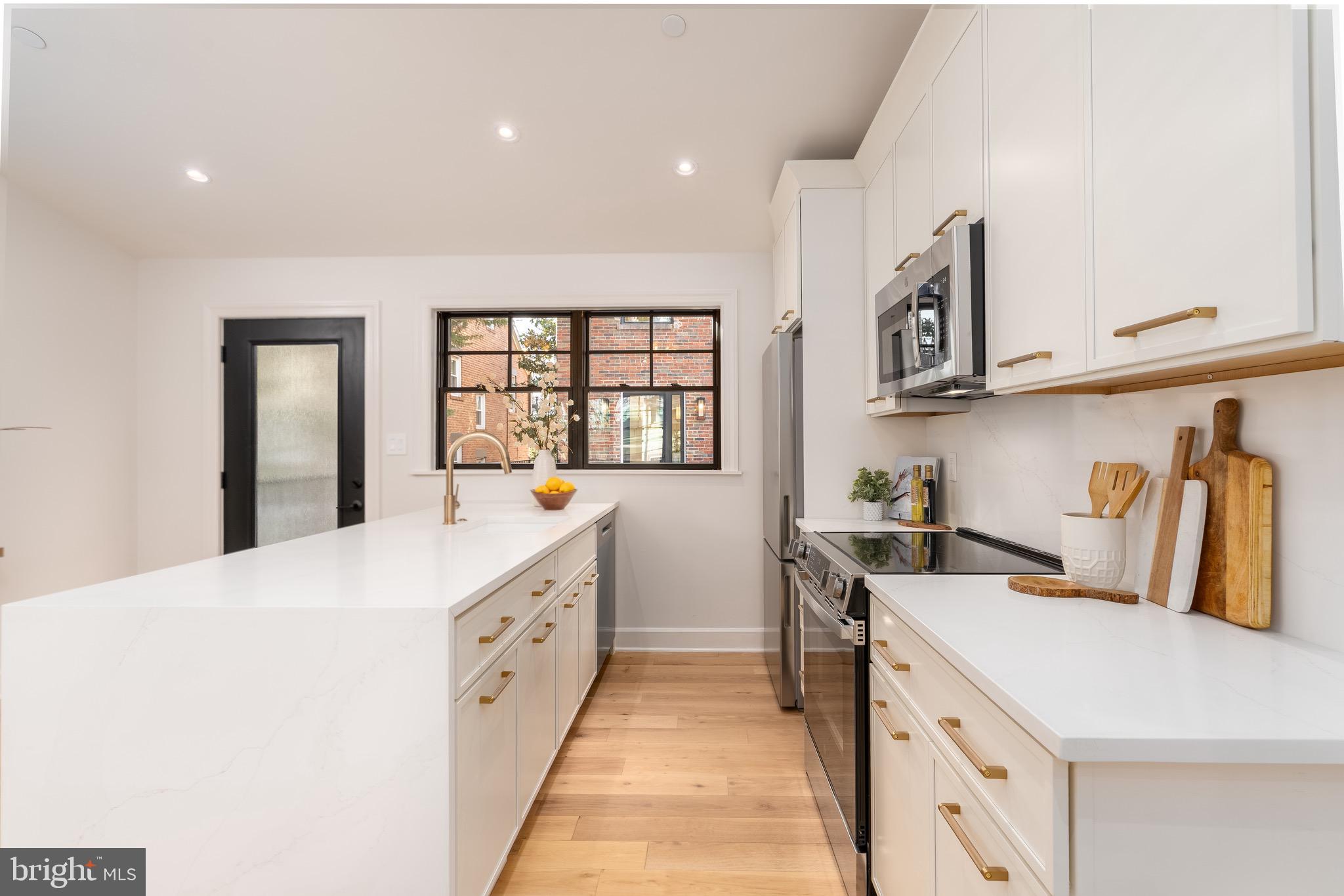 2619 Wisconsin Avenue Northwest Washington, DC 20007 - Photo 59 of 63 a large white kitchen with sink and washing machine
