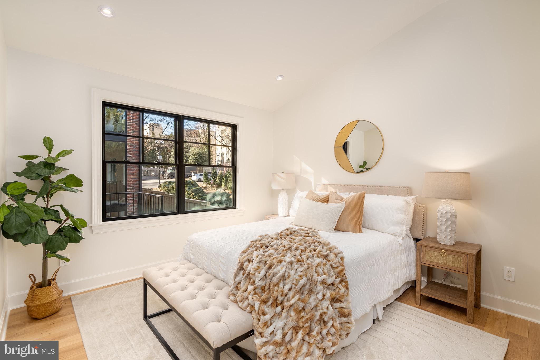 2619 Wisconsin Avenue Northwest Washington, DC 20007 - Photo 61 of 63 a bedroom with a bed and a potted plant next to a window