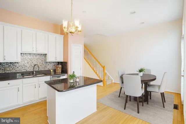 a view of a kitchen with microwave and wooden floor