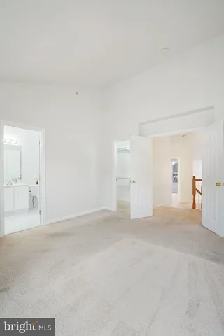 a bedroom with a bed and a potted plant