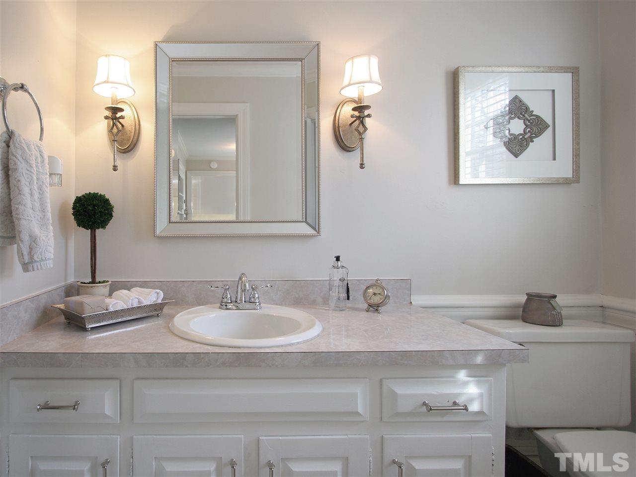 1004 Queensferry Road Cary, NC 27511 - Photo 14 of 25 Powder room is conveniently located for privacy and for easy access when you come in through the garage.