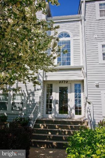 8378 Montgomery Run Road, Unit C Ellicott City, MD 21043 - Photo 1 of 16 front view of a house with a small yard